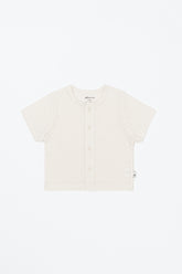 Avauma Lucent Short Sleeve Cardigan in Oat Latte color laid flat – lightweight summer knitwear for babies.